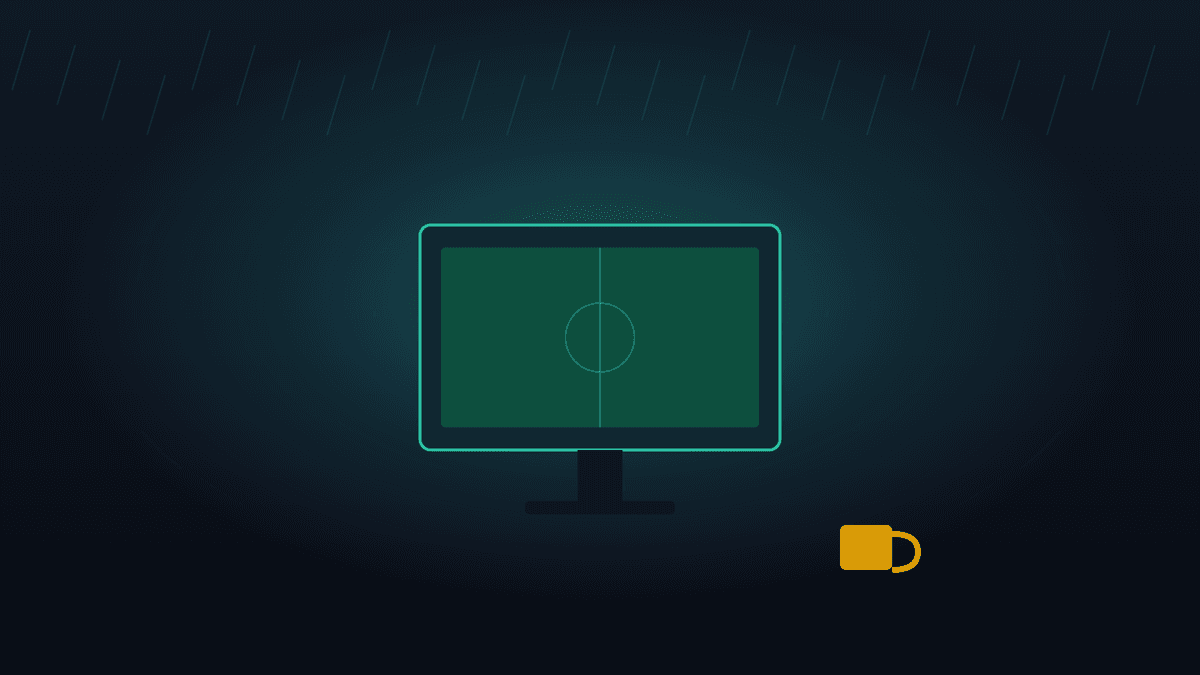 A UK living room at night with a football match on the television and a phone resting on the sofa arm